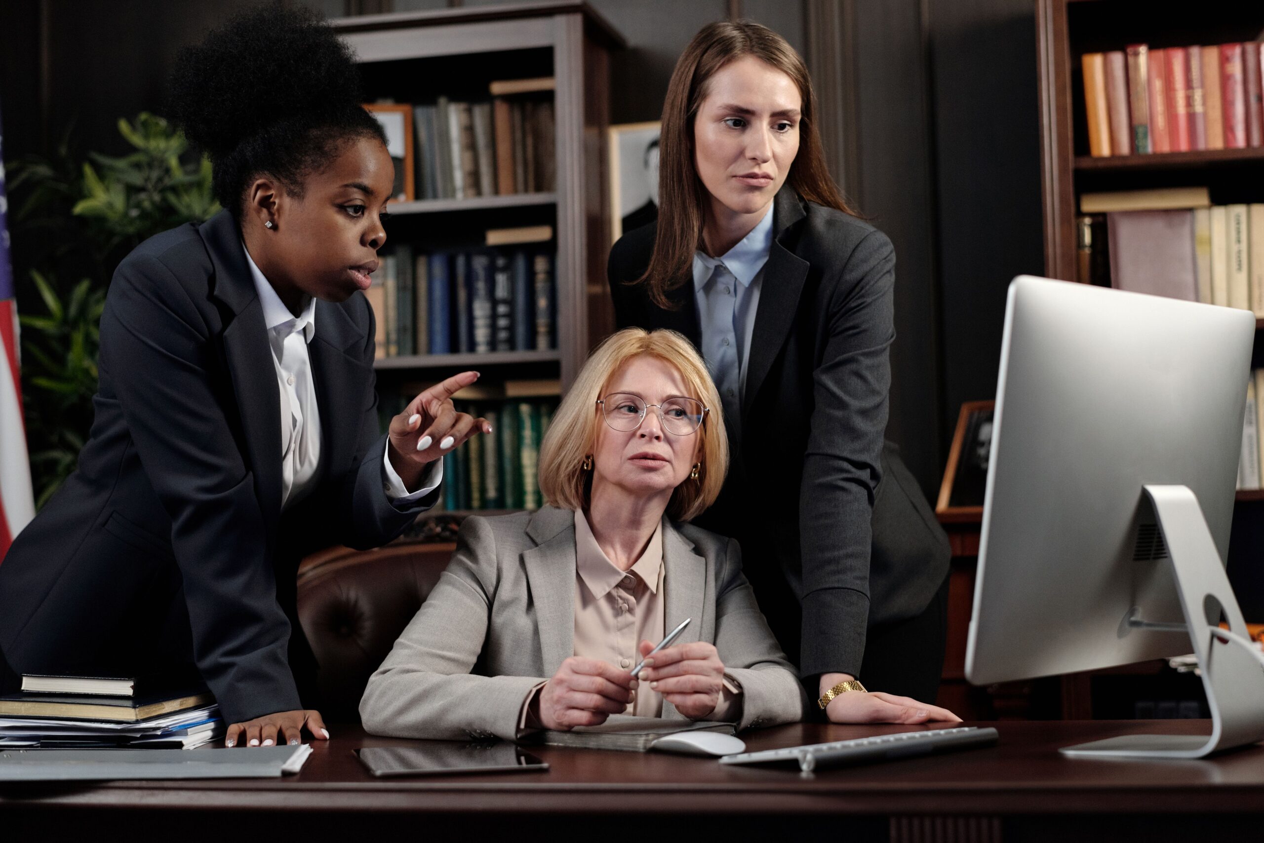 business leaders comparing consulting firms on a laptop before contacting any of them